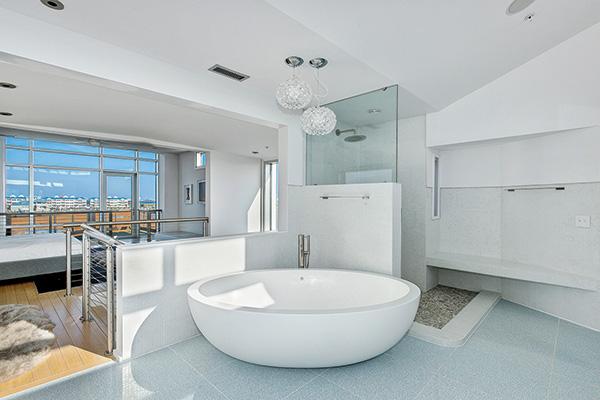 The master bathroom is outfitted with Boffi built-ins, fixtures and a 600-pound custom Corian tub that was crane-hoisted to its place on the terrazzo tile floor.