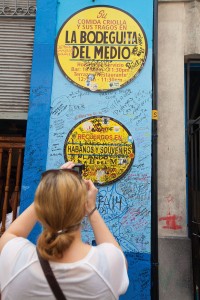 A tourist photographs the sign of the Bodeguita del Medio in old town Havana, a well-known tourist destination patronized by writer Ernest Hemingway and poet Pablo Neruda.