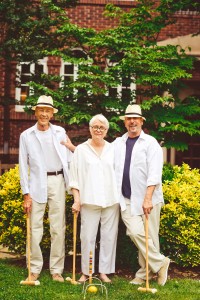 Painter Harriet Cole joins Russ Volker (left) and his husband, Mark Panos Volker, at a croquet-themed Friday happy hour in the courtyard.