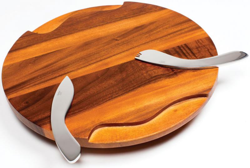 SLICE OF LIFE The Nambé cheeseboard with magnetized utensils simplifies your party prep by an inch, but maybe more importantly, the sculptural design factor elevates your modern setting. $100, at The Store LTD in Cross Keys.