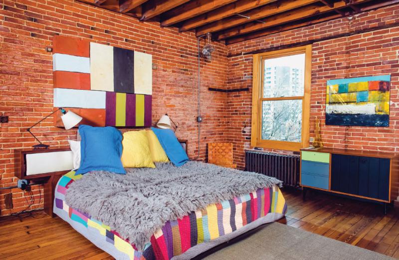 In the master bedroom, Lat’s colorful wall sculpture—an homage to Sean Scully—hangs above the couple’s bed, creating the most colorful area in the house. 