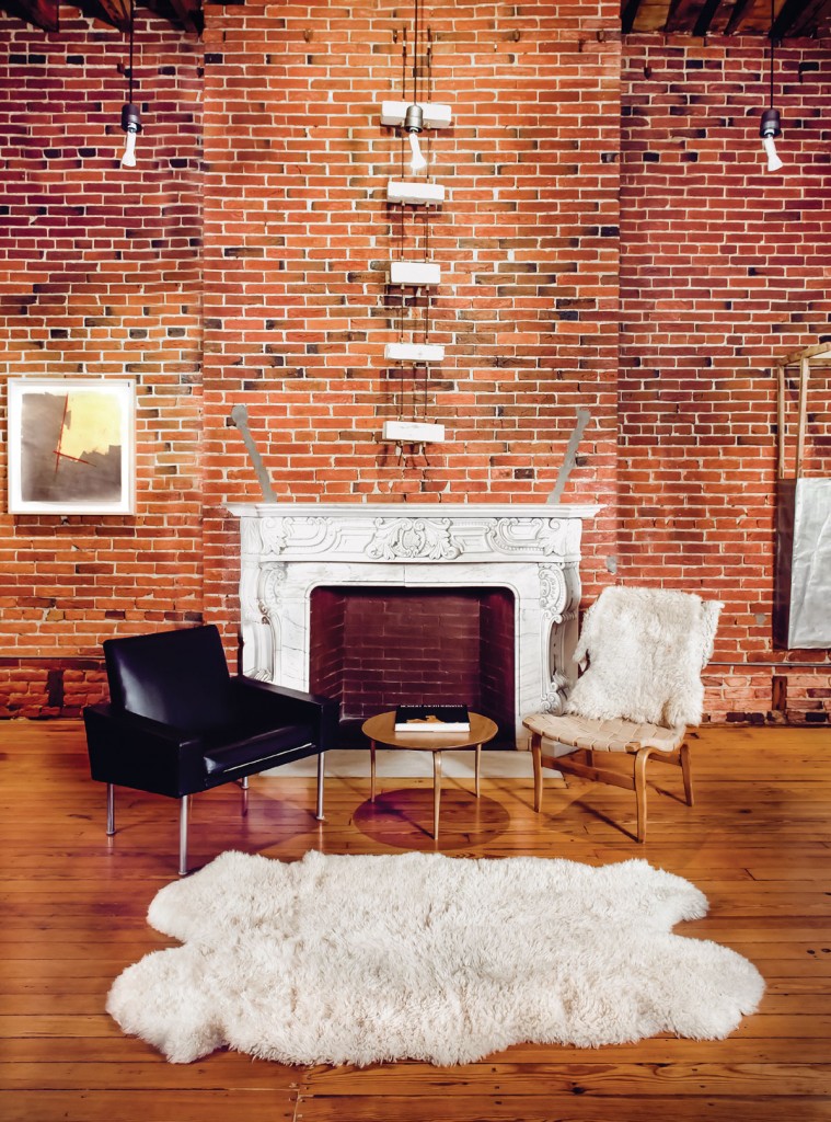 Naylor’s artwork, made from materials from the house, hangs in the background. The black chair was designed by Hans Wagner, and the wooden chair is Bruno Mathsson. The rug is made of sheepskin.