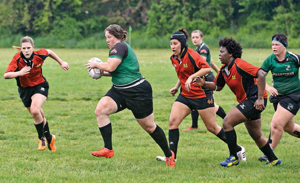 Erin Sylvester of the Chesapeake Women's Rugby Football Club runs with the ball as members of the Maryland Stingers give chase during a game April 23 at Frank C. Bocek Park in Baltimore.