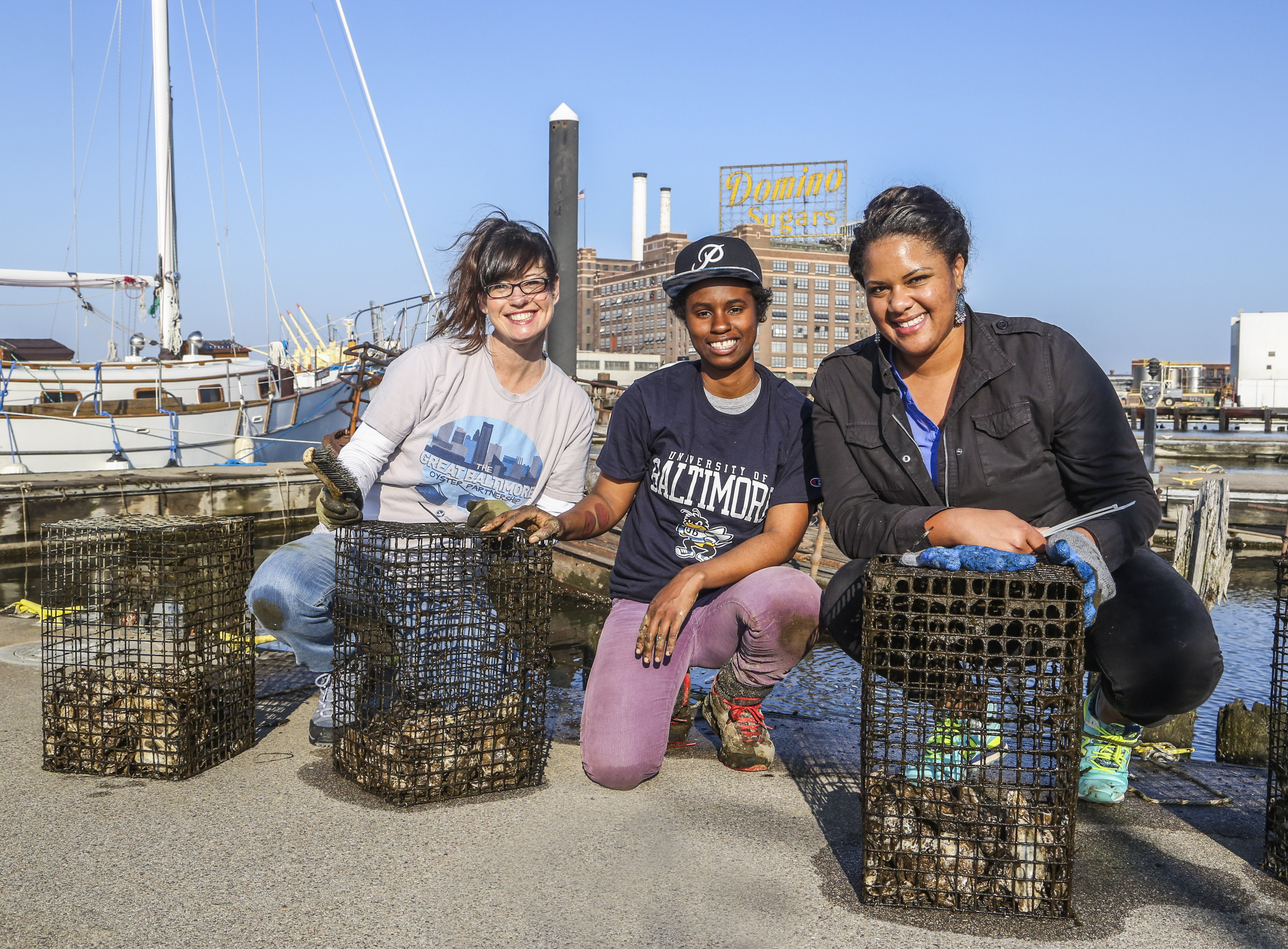 Tammy Dexter, Lanae Jackson and Carmera Thomas clean oyster cages.