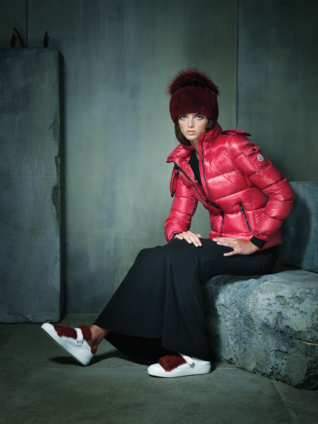 Sporty spice. Red “Bady Giubbotto” puffer coat, $1,045 and “Lucie” sneaker with fur adornment, $495, both by Moncler, at Moncler, CityCenterDC. Red fur beanie with fox pom-pom, $295 at Mano Swartz, Green Spring Station. Black matte jersey long-sleeved gown with leather detailing by Alice + Olivia, $330 at L’Apparenza, Falls Road.
