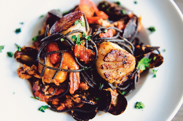 Donovan’s Squid Ink Fra Diavolo, above, is black squid-ink spaghetti with seared scallops, shrimp, mussels, crab and  spicy tomato sauce